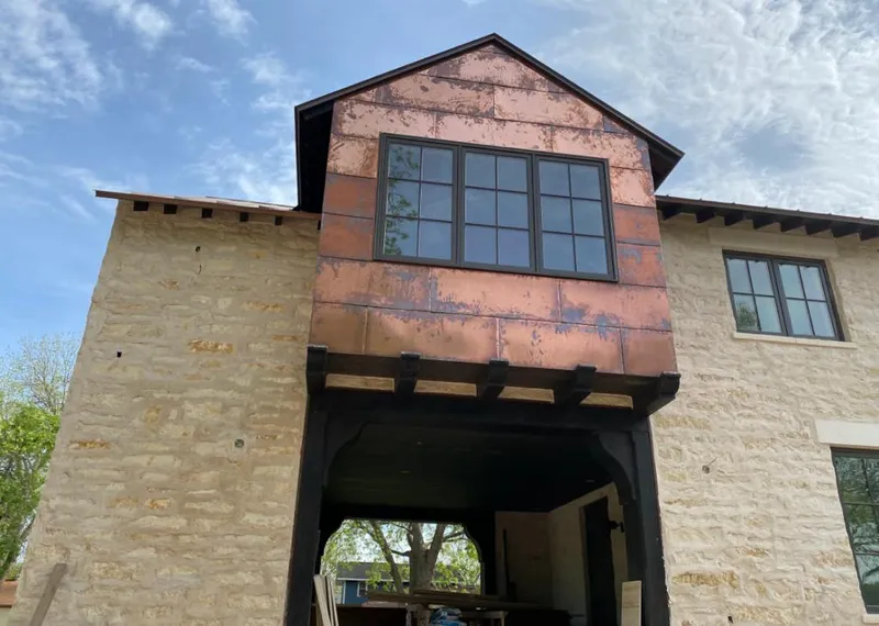 Copper metal panel facade on a stone building for Skylight Installation in Collierville