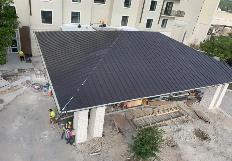 Metal roofing installation team working on a commercial building in Collierville