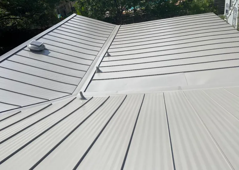 Solar attic fan installed on a metal roof for Roof Ventilation in Collierville